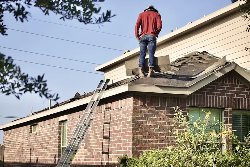 Professional roofer working on a residential roof in The Trails
